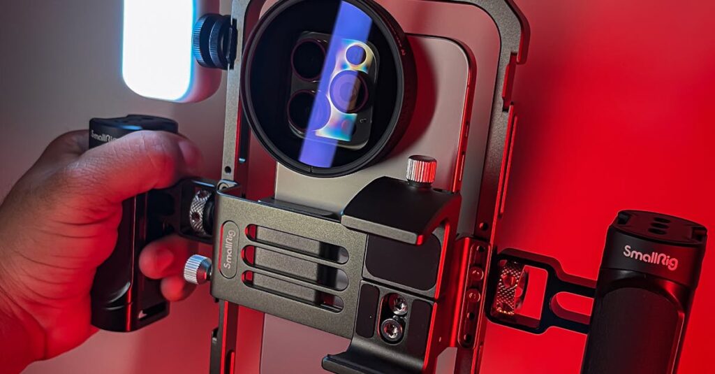 Close-up of a camera rig with LED light in a red-lit environment, capturing vibrant colors.